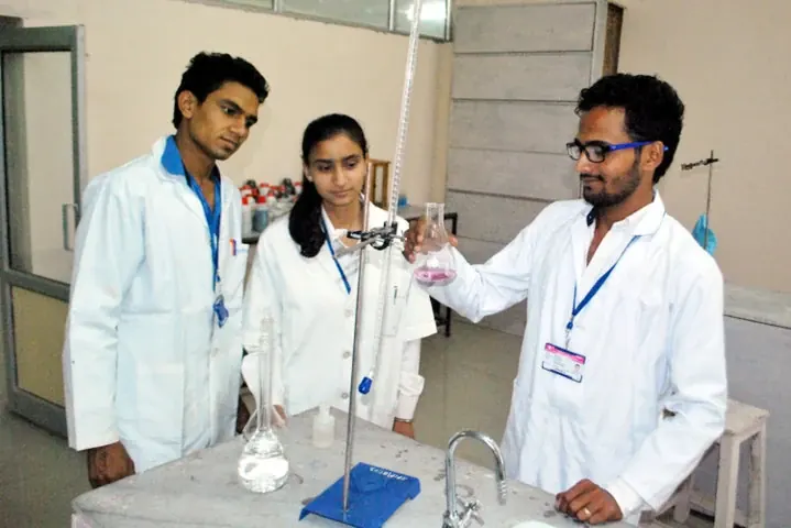 Students practising laboratory technique in prescribed lab coats