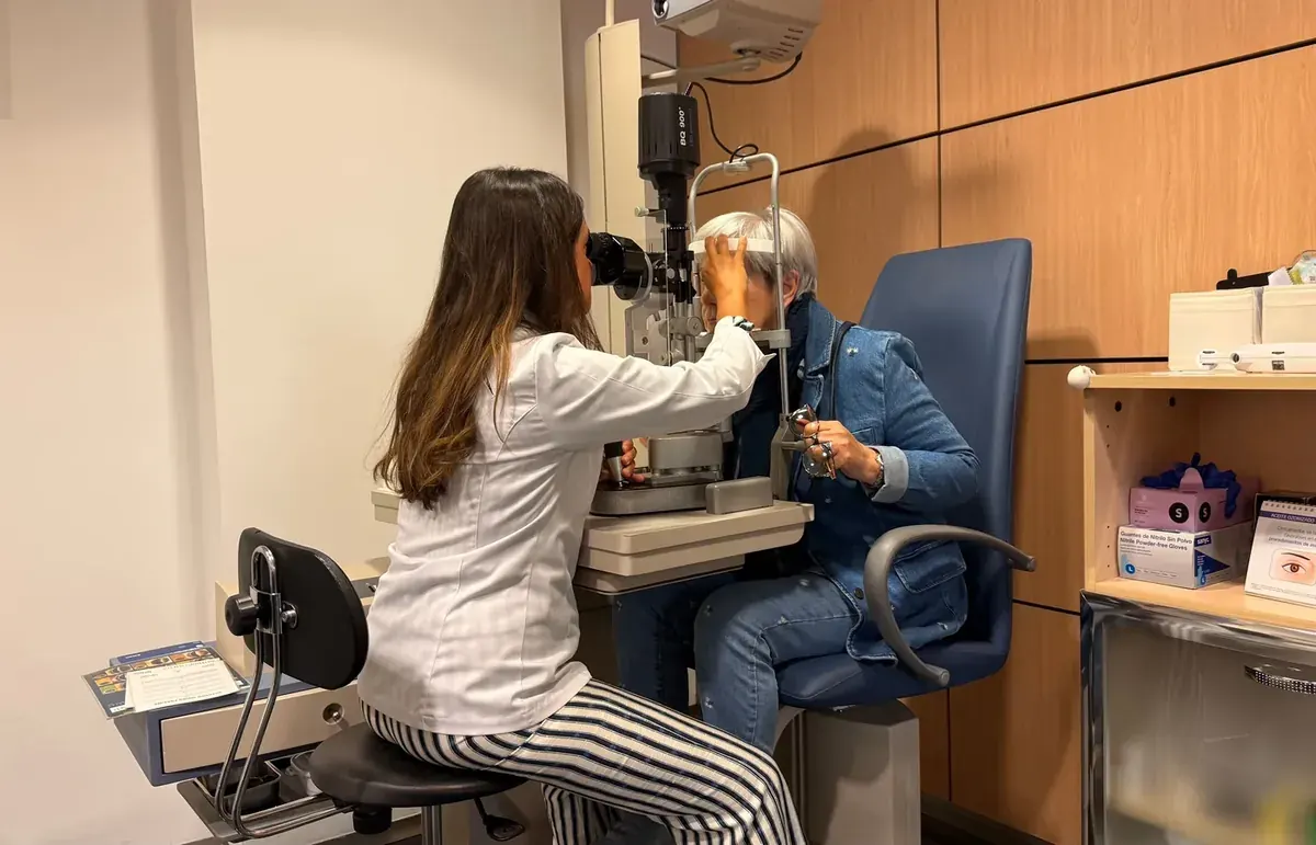 Optometrist conducting an eye examination with a slit lamp
